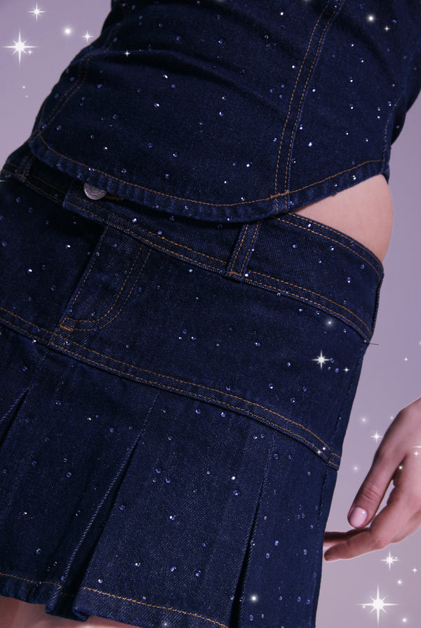 Displays a model wearing the Disney 'Juicy' branded denim diamanté scatter pleated skirt