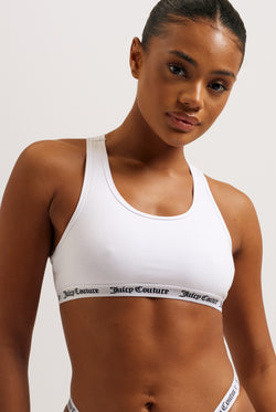 Displays a model wearing the White 'juicy' branded cotton bralette 