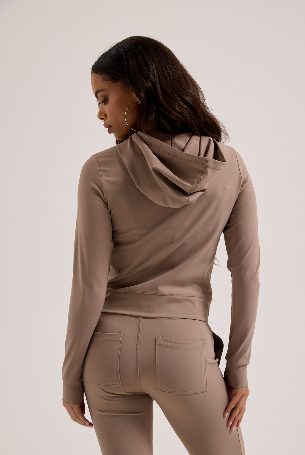 Displays a model wearing the Fungi peached 'Juicy' branded active fitted hoodie