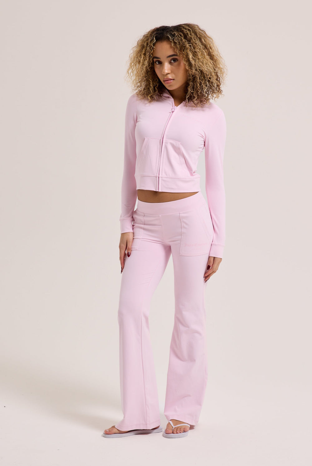 Displays a model wearing the Cherry Blossom peached 'Juicy' branded active fitted hoodie 