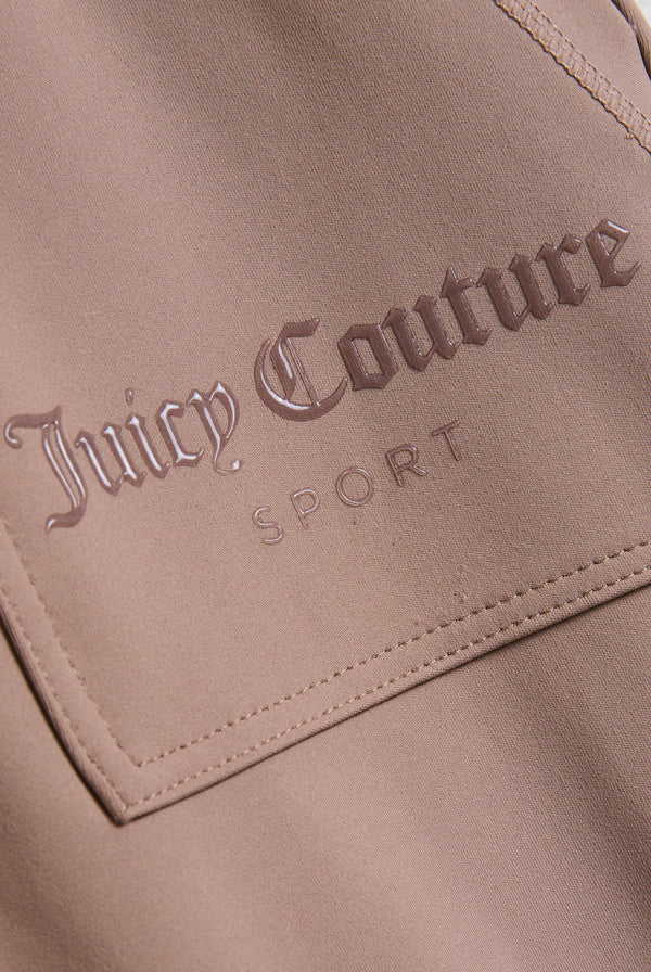 Displays the Fungi peached 'Juicy' branded active low rise pants featuring the juicy Couture sport branding 