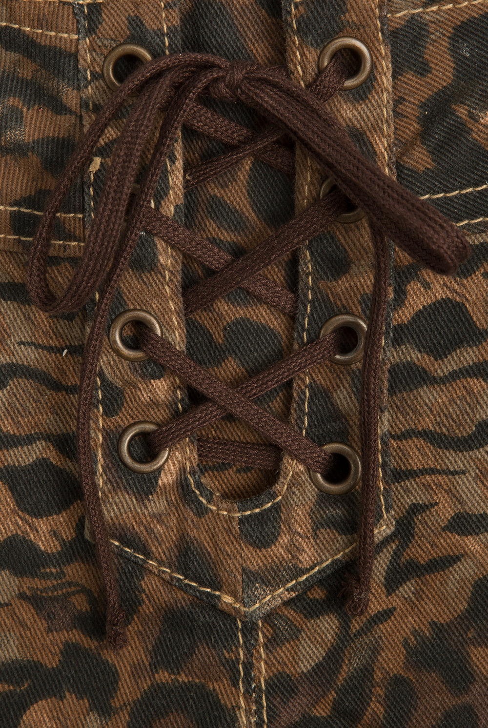 Displays the animal 'Juicy' branded denim lace up shorts featuring the close up on the details 