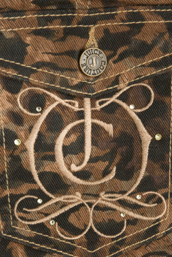 Displays a model wearing the animal 'Juicy' branded denim lace up shorts featuring the juicy Couture logo branding 