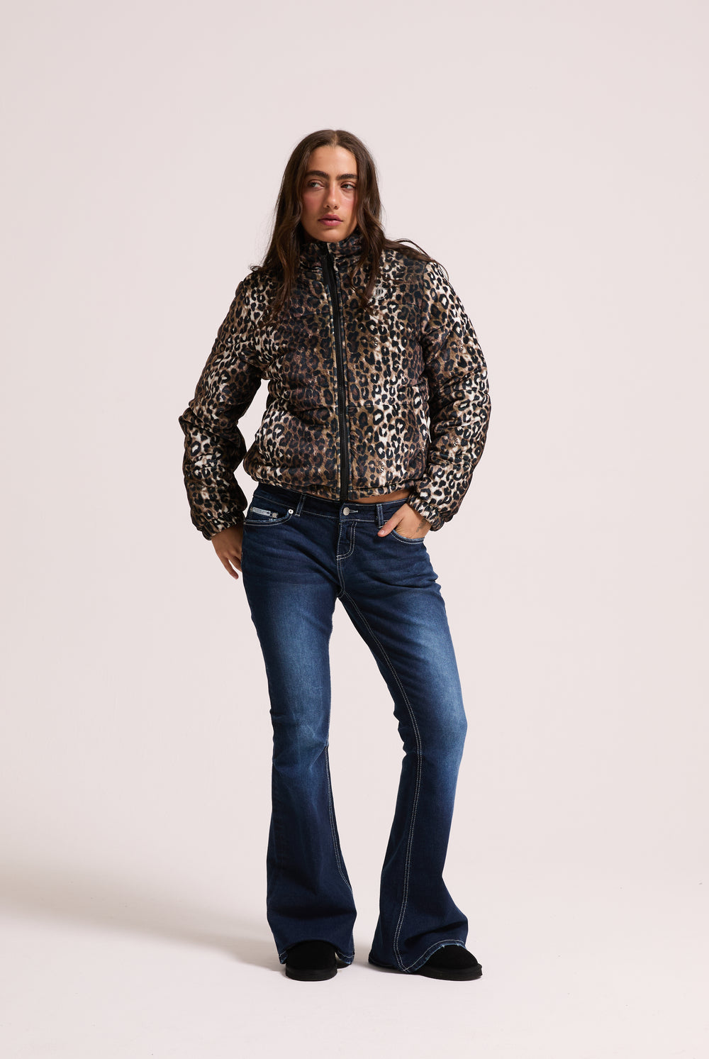 Displays a model wearing the leopard print velour 'Juicy' branded puffa jacket