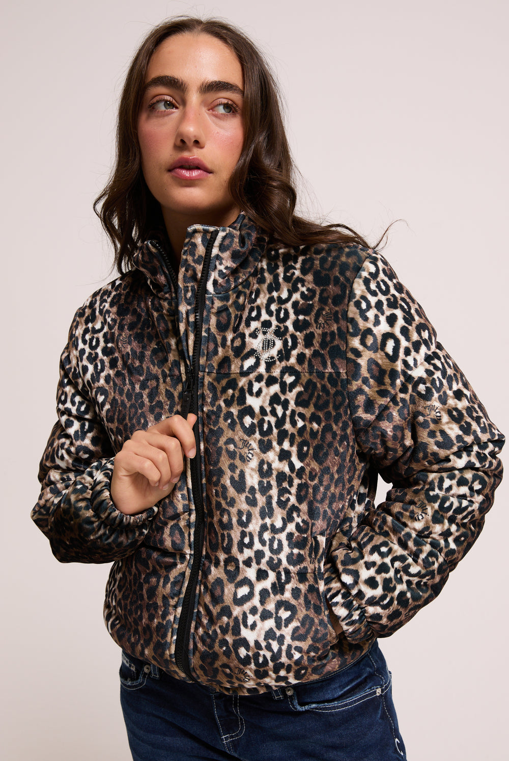 Displays a model wearing the leopard print velour 'Juicy' branded puffa jacket