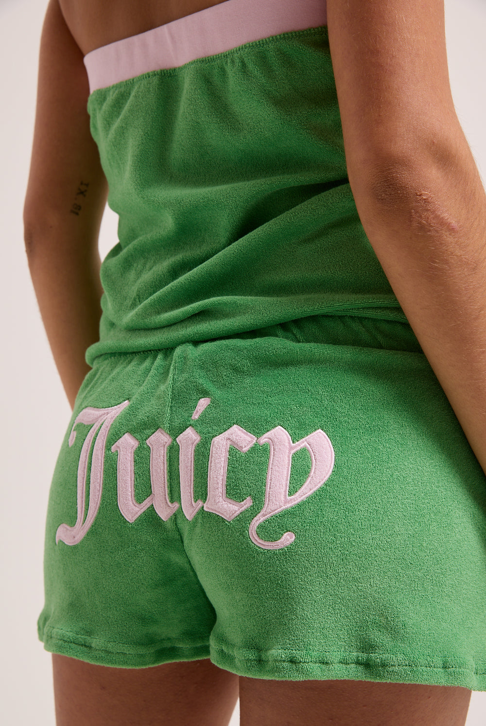 Displays a model wearing the Peppermint Appliqué 'Juicy' branded Terry towelling romper 
