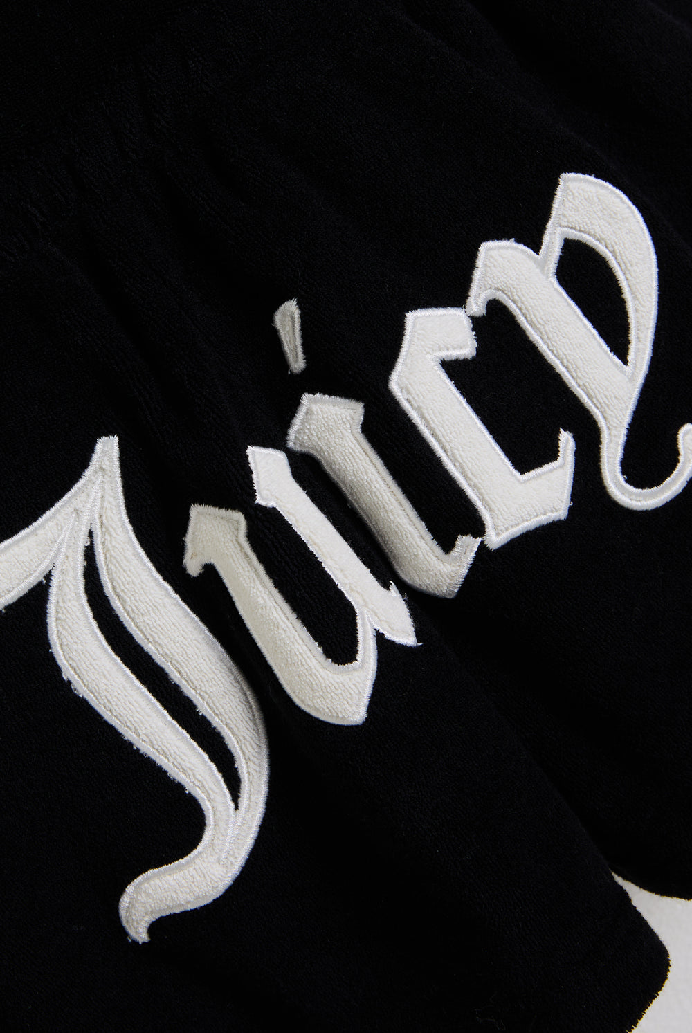 Displays the Black Appliqué 'Juicy' branded Terry towelling romper featuring the juicy branding 