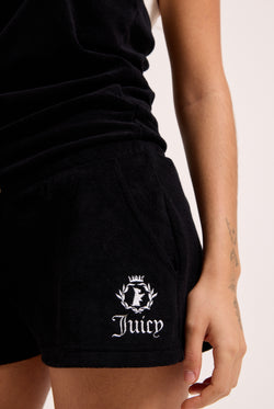 Displays a model wearing the Black Appliqué 'Juicy' branded Terry towelling romper featuring the juicy logo