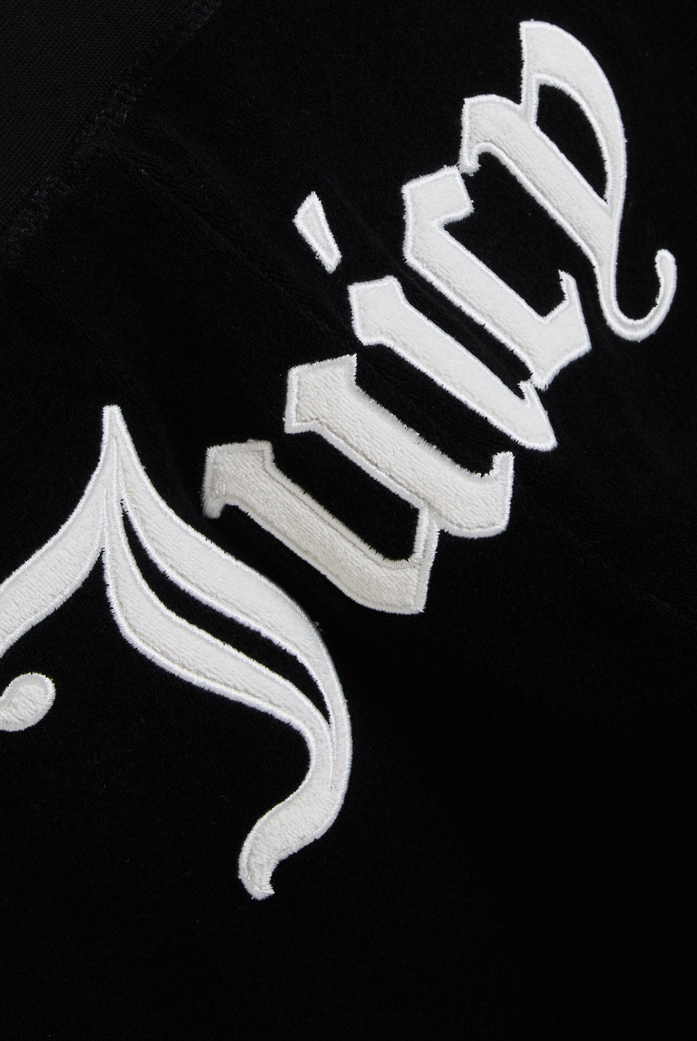 Displays the Black appliqué 'Juicy' branded Terry ultra low straight track pants featuring the juicy branding 
