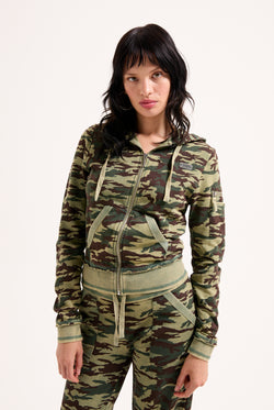 Displays a model wearing the Camo Print 'Juicy' branded washed cotton hoodie 