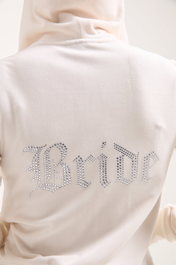Displays a model wearing the Bridal 'Juicy' branded classic velour hoodie featuring the bridal branding 
