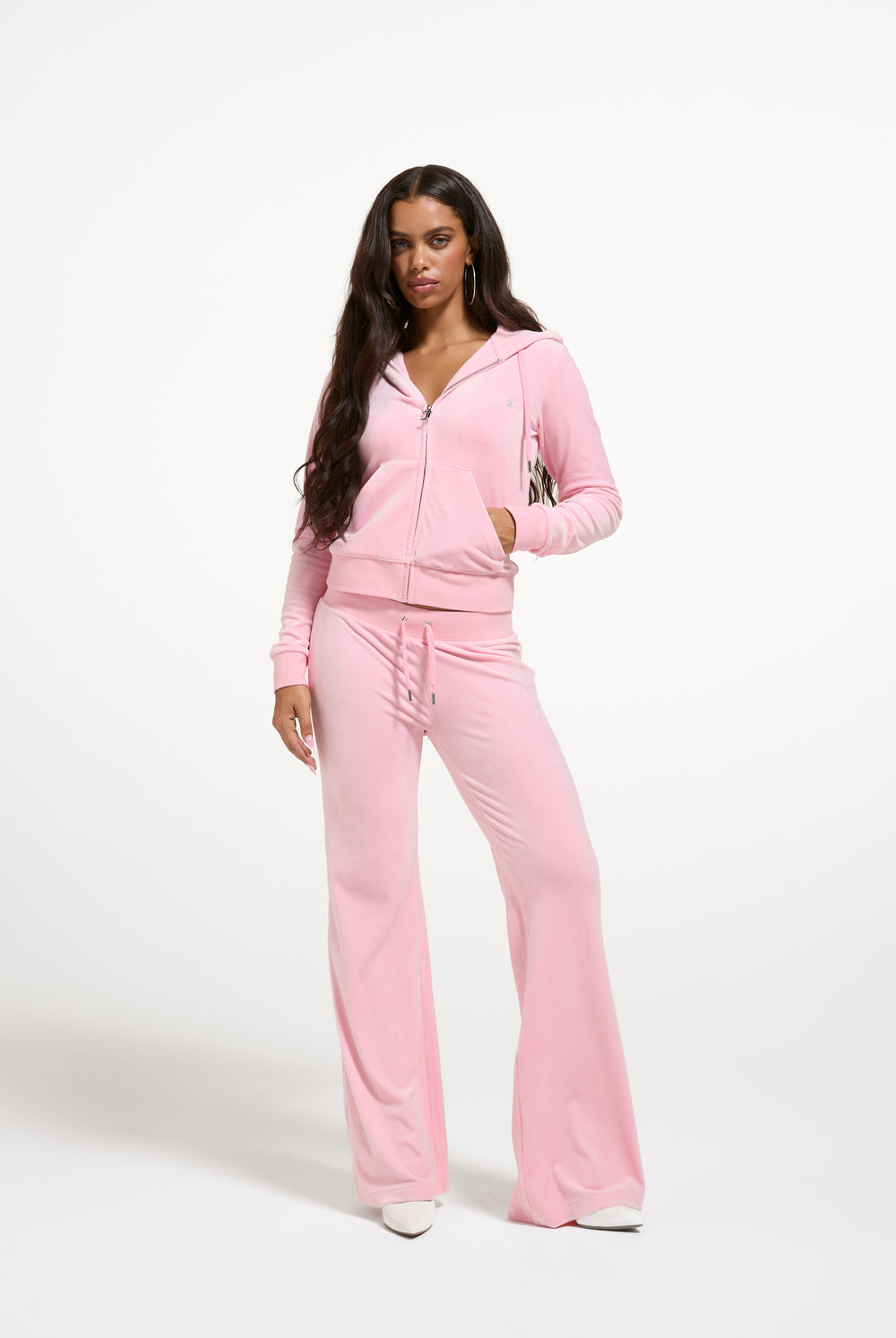 Displays a model wearing the Juicy Pink 'Juicy' branded bridesmaid classic velour low rise track pants 