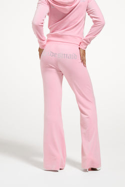 Displays a model wearing the Juicy Pink 'Juicy' branded bridesmaid classic velour low rise track pants 