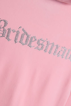 Displays the Juicy Pink 'Juicy' branded bridesmaid classic velour hoodie featuring juicy branding 'bridesmaid' logo