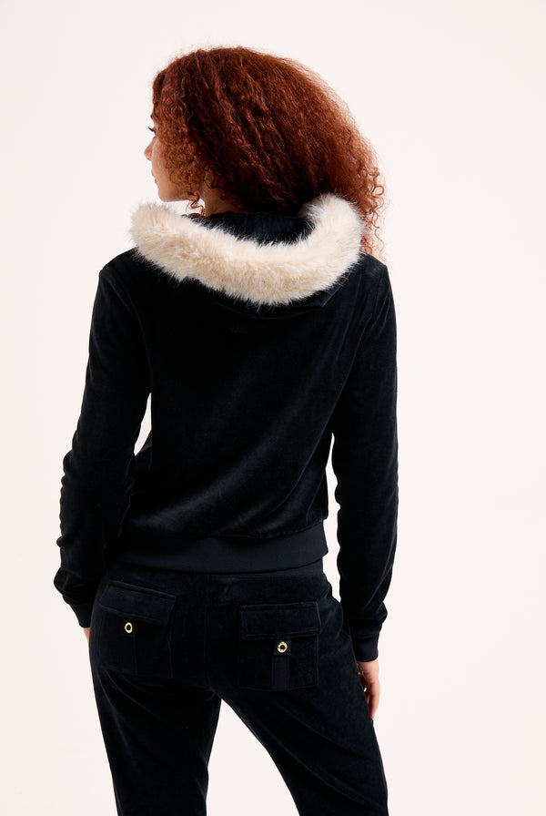 Displays a model wearing the Black 'Juicy' branded Pom Pom faux fur bamboo velour hoodie 