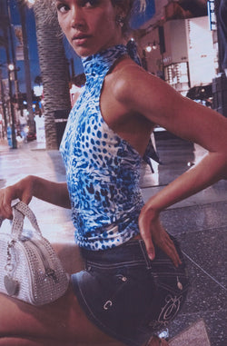 Displays a model wearing the Blue Leopard Print 'Juicy' branded jersey halter neck top 