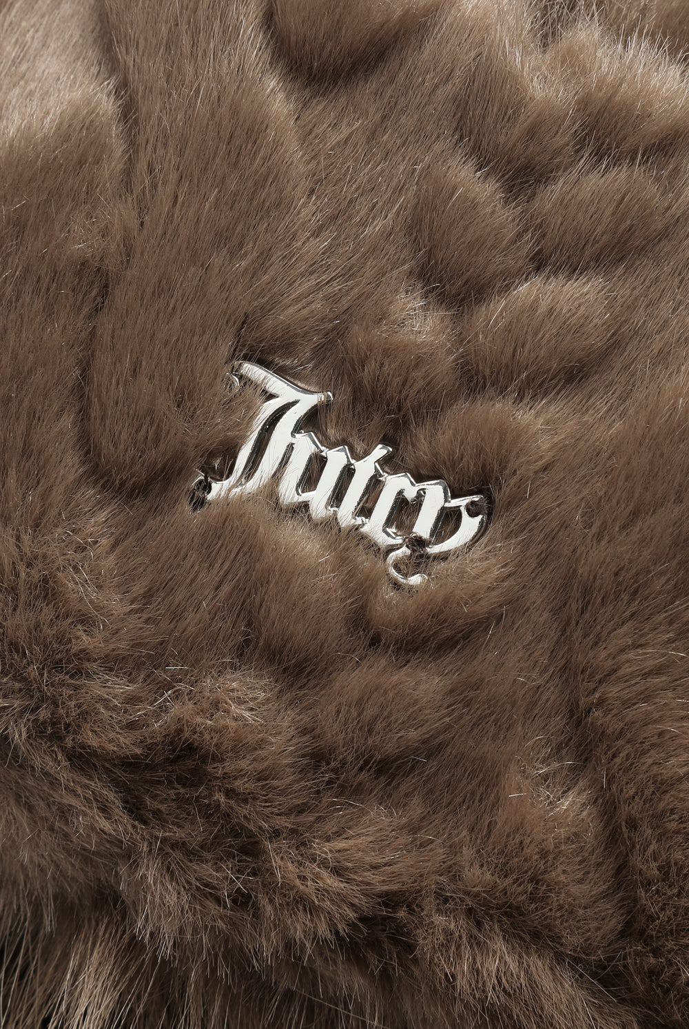 Displays the Java 'Juicy' branded Cable Knit Trapper With Fur Lining featuring the juicy branding