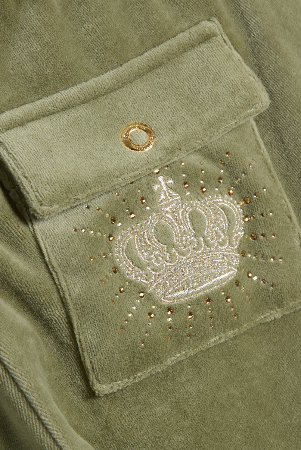Displays the Oil Green 'Juicy' branded Regal Rebelle Caisa Ultra Low Rise Pant featuring the juicy couture branding