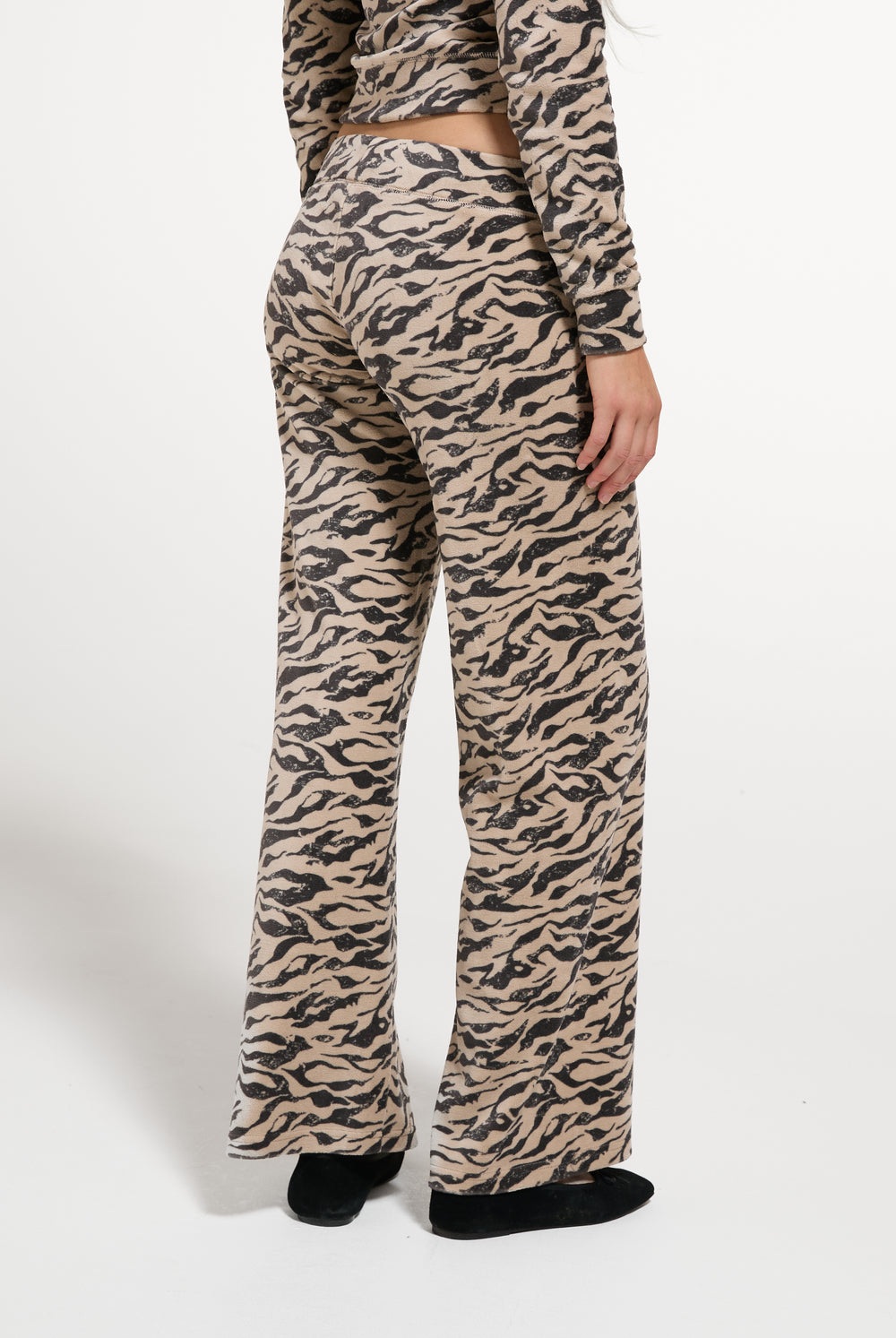 Displays a model wearing the Camo Zebra 'Juicy' branded Washed Og Straight Trackpant