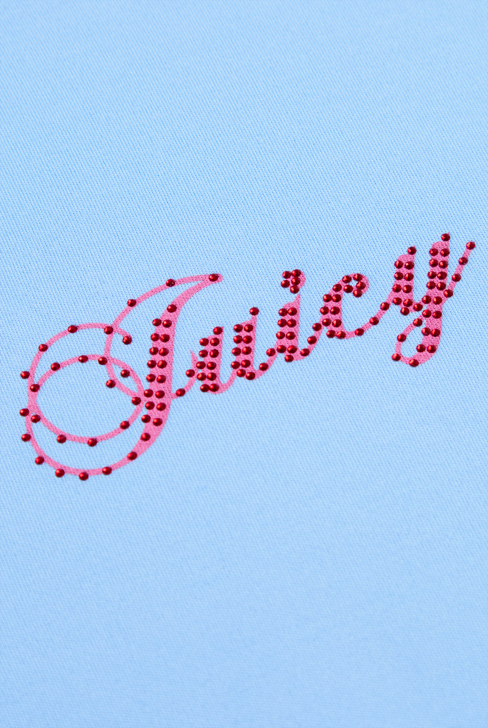 Displays the Powder Blue 'Juicy' branded Script Diamante Baby Tee featuring the details on the juicy branding 