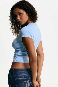 Displays a model wearing the Powder Blue 'Juicy' branded Script Diamante Baby Tee