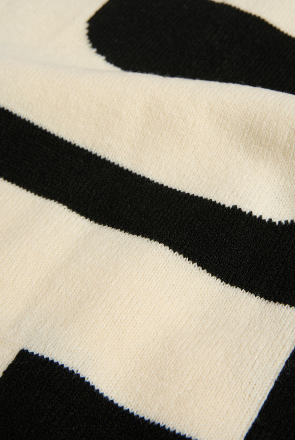 Displays a 'Choose Juicy' knitted scarf