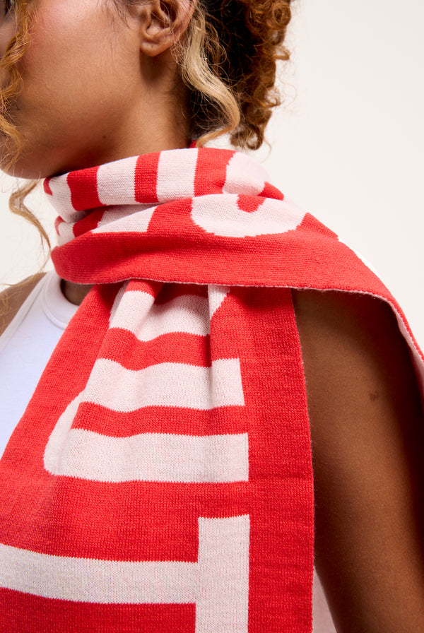 Displays a model wearing the Cream & Coral Contrast 'Juicy' branded football scarf 