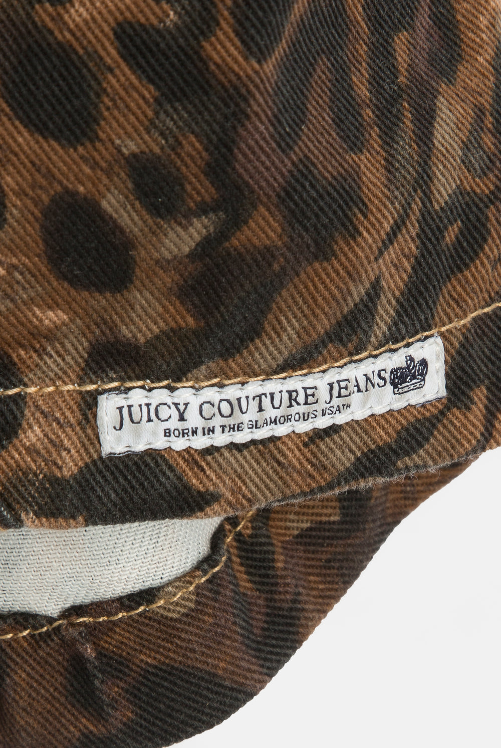 Displays the Animal 'Juicy' branded denim lace up corset featuring the close up on the juicy Couture jeans branding 