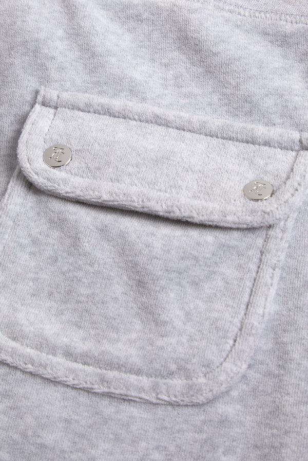 Close-up of the back pocket, showing a more detailed view of the Juicy Couture logo on the silver buttons