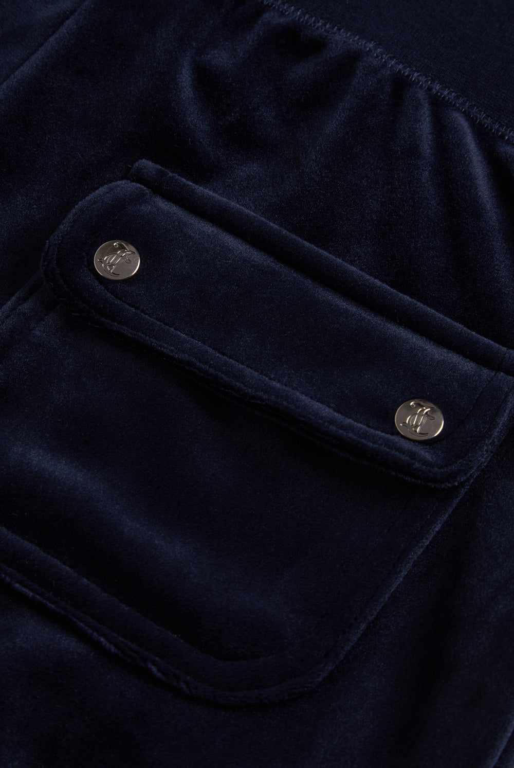 Juicy Couture Navy velour tracksuit bottoms - close up of the back pocket with two silver branded poppers