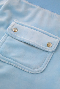 Displays a model wearing the Powder blue classic 'Juicy' branded velour del ray pocketed bottoms featuring the pocket