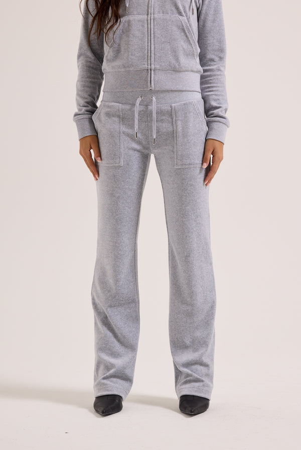 Person wearing a gray tracksuit on a white background