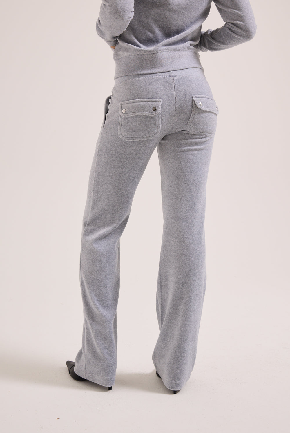 Gray pants worn by a person on a plain background