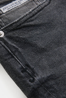 Displays a models wearing the Washed Black 'Juicy' branded low rise denim booty shorts featuring the juicy logo