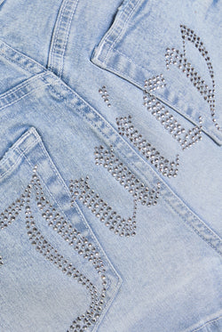 Displays the Light Wash 'Juicy' low rise denim booty short 