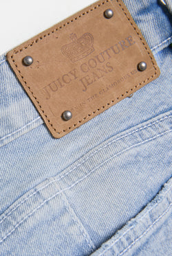 Displays the Light Wash 'Juicy' low rise denim booty short 