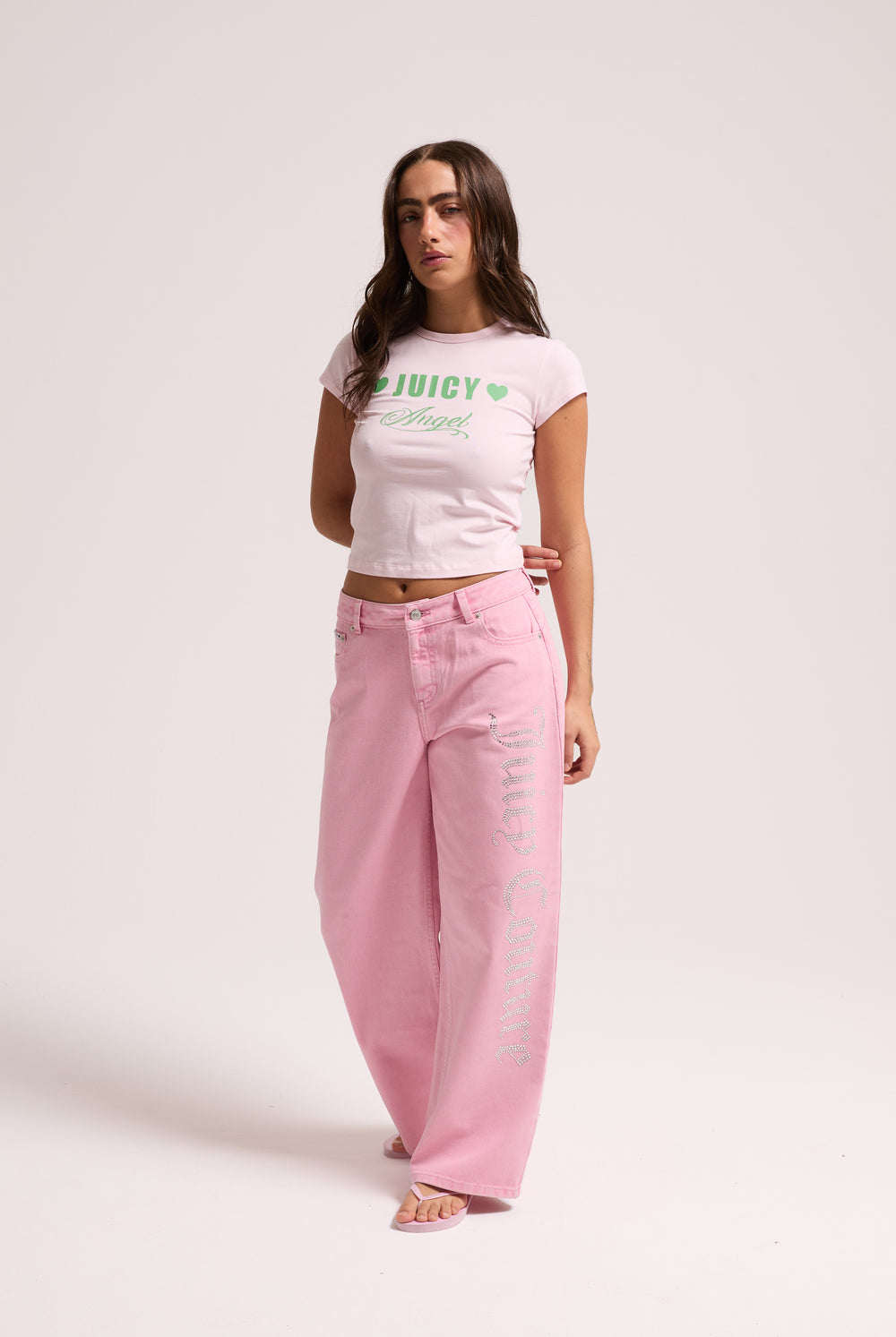 Displays a model wearing the Pink Wash 'Juicy' branded Diamanté wide leg jeans 