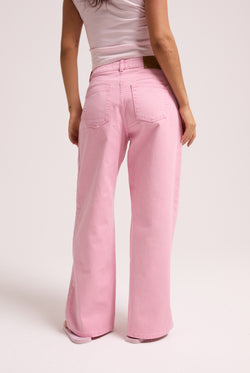 Displays a model wearing the Pink Wash 'Juicy' branded Diamanté wide leg jeans 