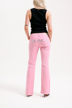 Displays a model wearing the Pink Wash 'Juicy' branded Digi Diamanté mid rise flared jeans