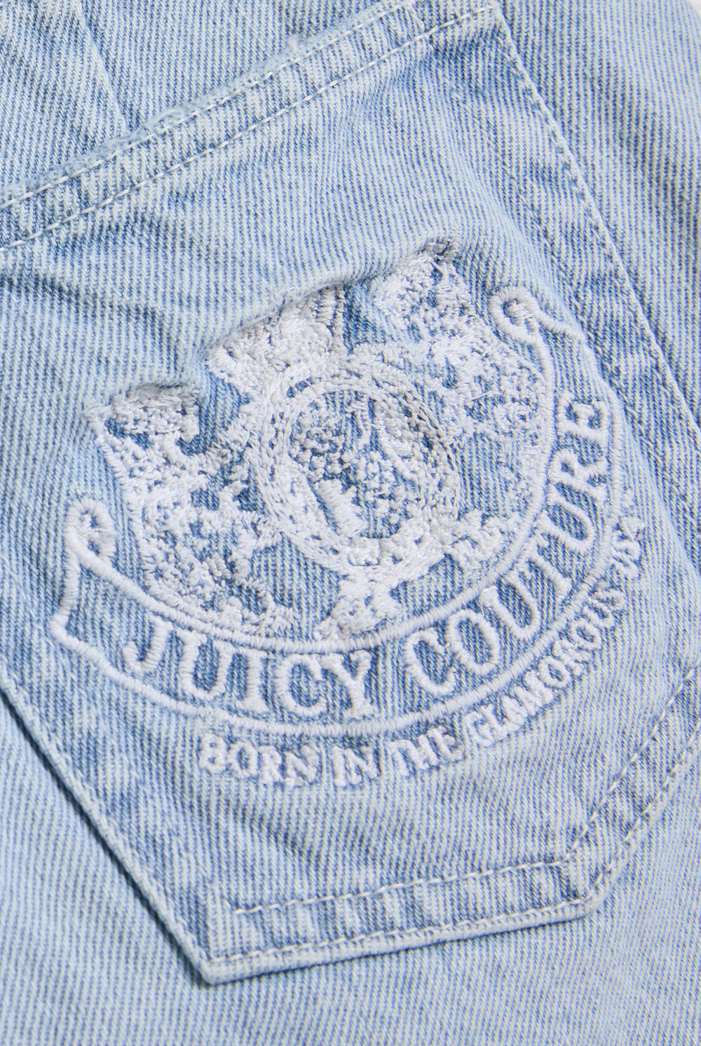 Displays the Light Wash 'Juicy' branded denim dog crest mini skirt featuring the juicy Couture branding 