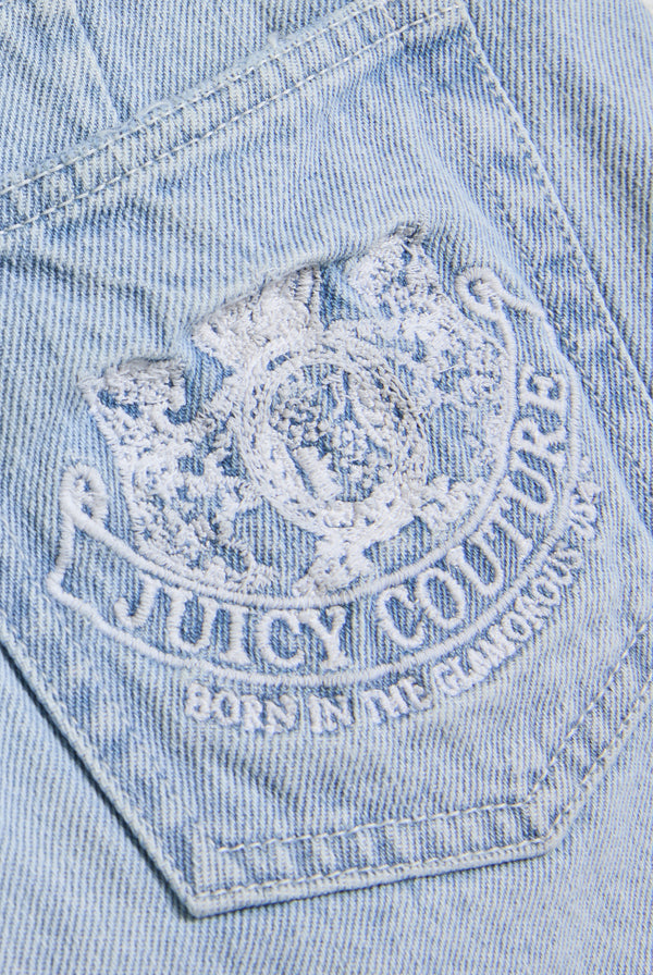 Displays the Light Wash 'Juicy' branded denim dog crest mini skirt featuring the juicy Couture branding 