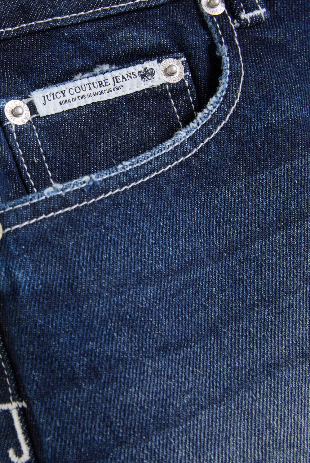Displays the Mid Wash 'Juicy' branded dog crest mini skirt