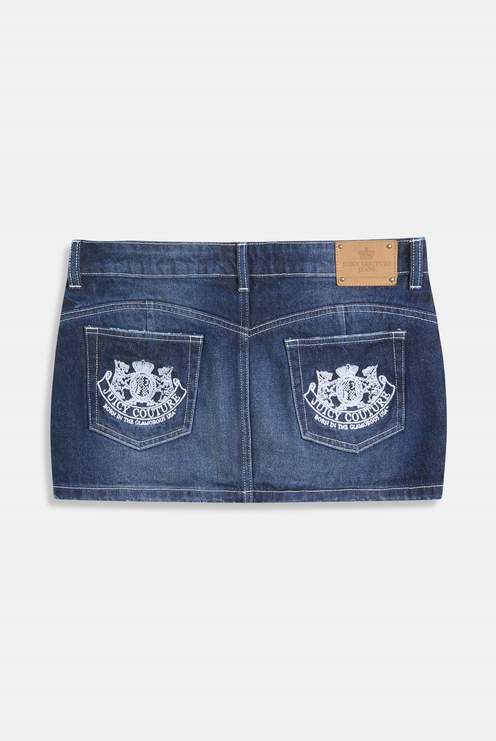 Displays the Mid Wash 'Juicy' branded dog crest mini skirt