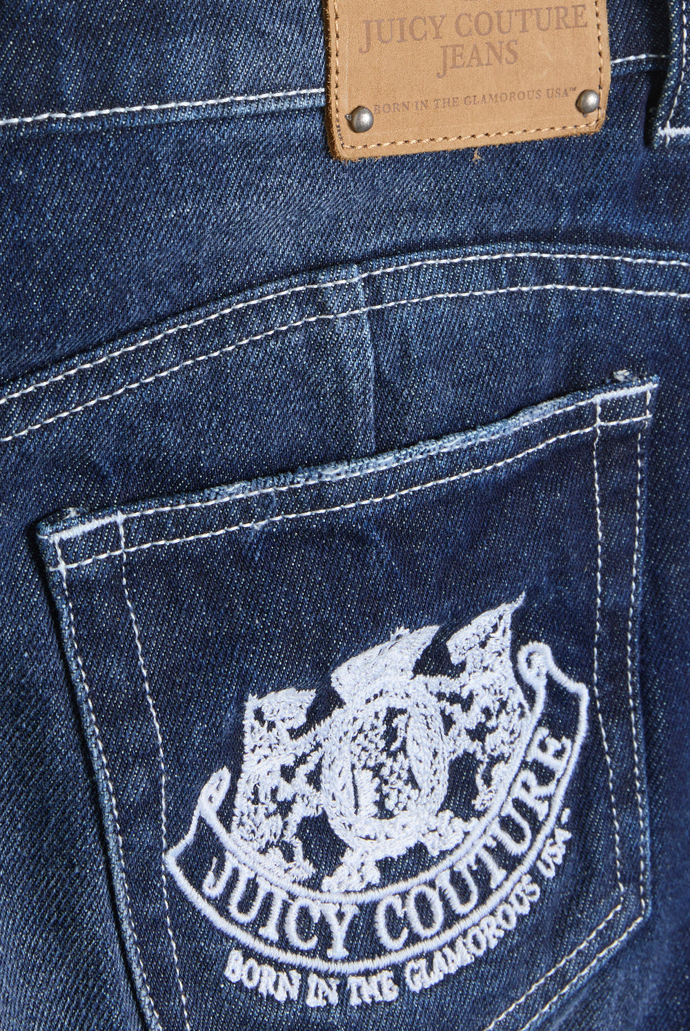 Displays the Mid Wash 'Juicy' branded dog crest mini skirt featuring juicy Couture logo
