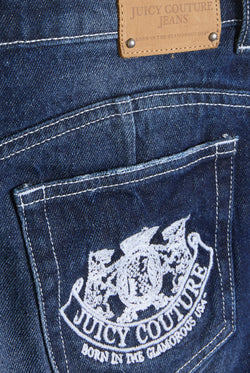 Displays the Mid Wash 'Juicy' branded dog crest mini skirt featuring juicy Couture logo