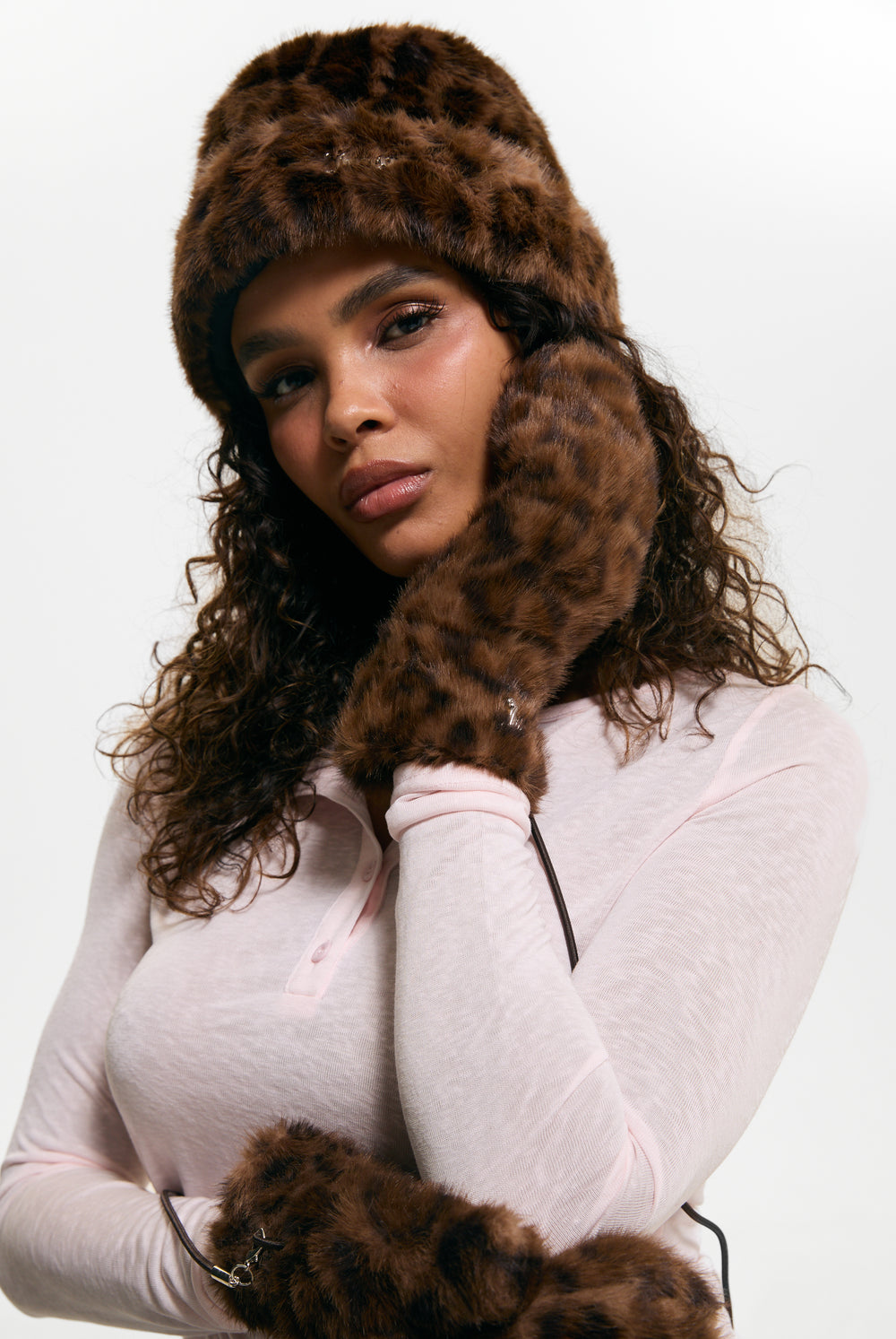 Displays a model wearing the Leopard Print 'Juicy' branded Drawstring Fur Mittens