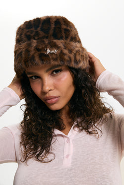 Displays a model wearing the Leopard Print 'Juicy' branded Faux Fur Hat