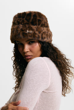 Displays a model wearing the Leopard Print 'Juicy' branded Faux Fur Hat