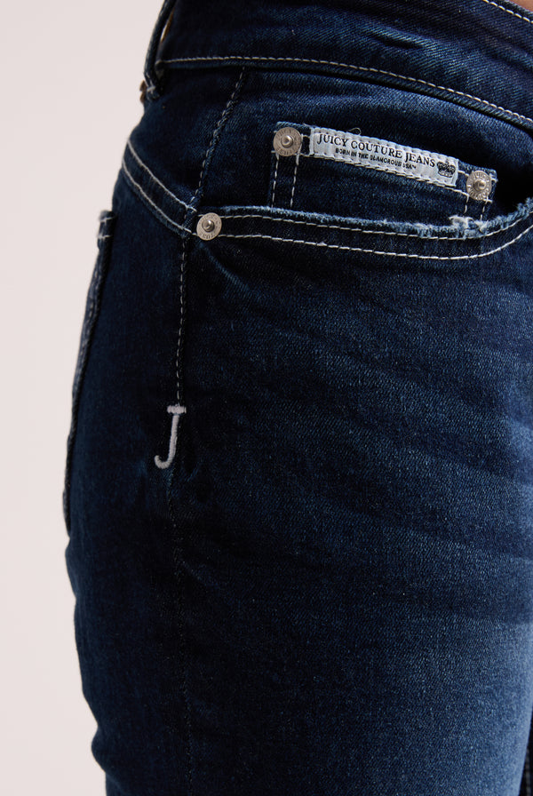 Displays the 'Juicy' branded mid wash diamanté low rise flare jeans 