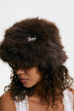 Displays a model wearing the Java 'juicy' branded Plaque Fur Bucket Hat